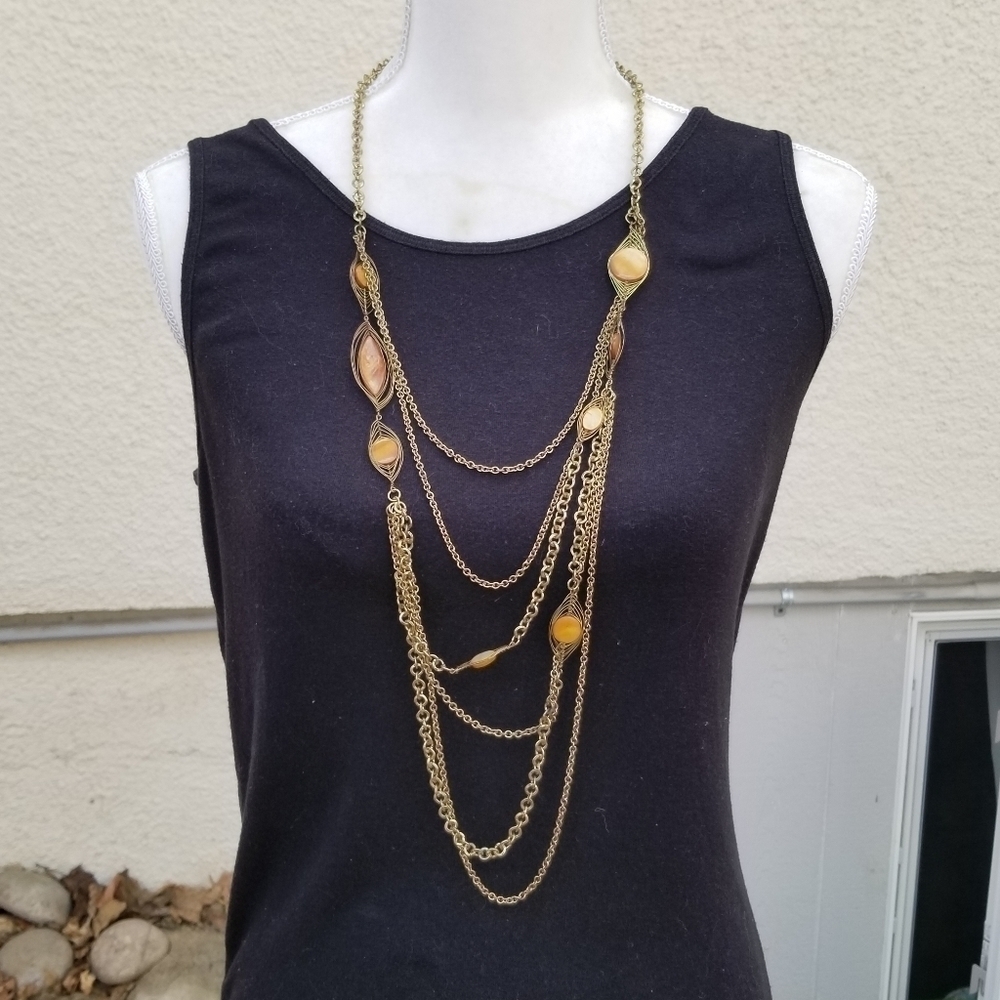 layered gold tone chain necklace with dyed shell accents